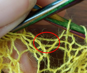 The area in red is in between 2 stitches and its where we need to put the yarn over.
